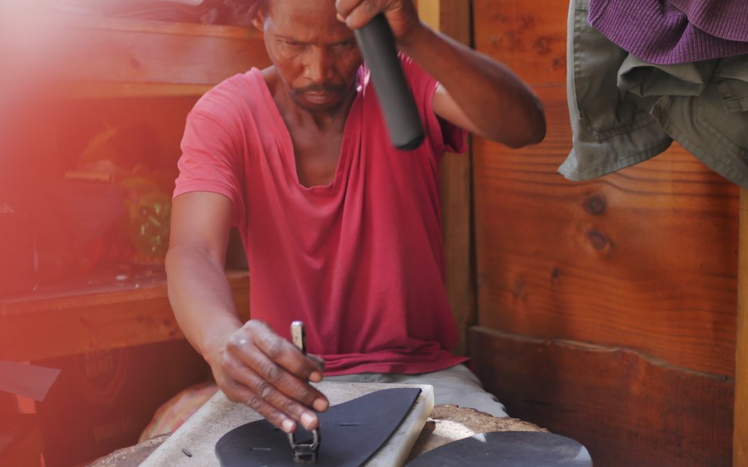 south african man making leather boots